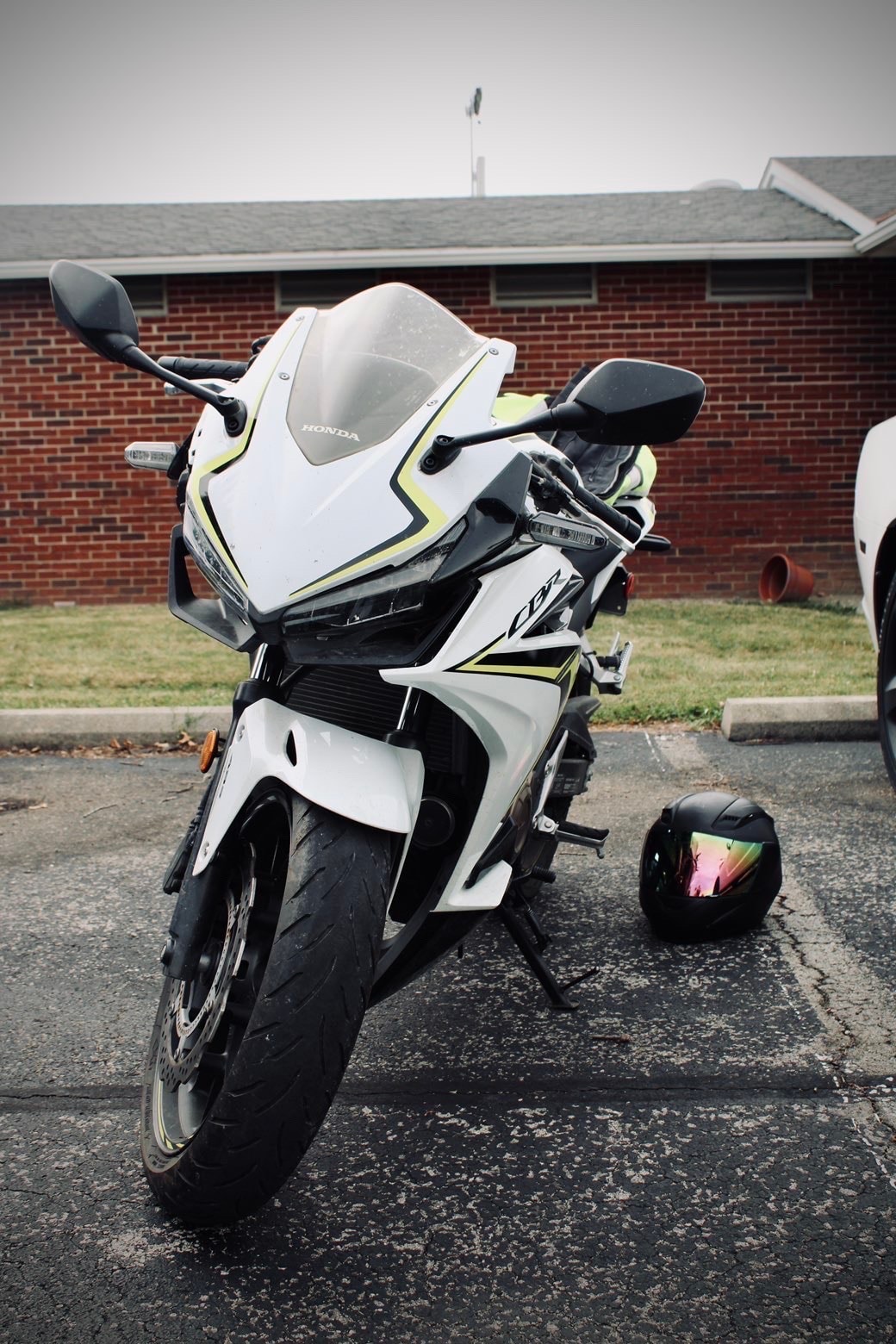 White Honda motorcycle with neon seat cover